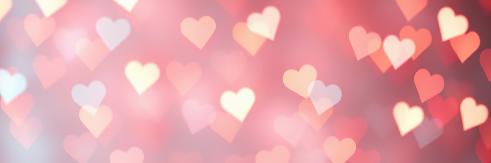 Colorful heart shaped bokeh lights are beautifully illuminating a romantic background for special occasions